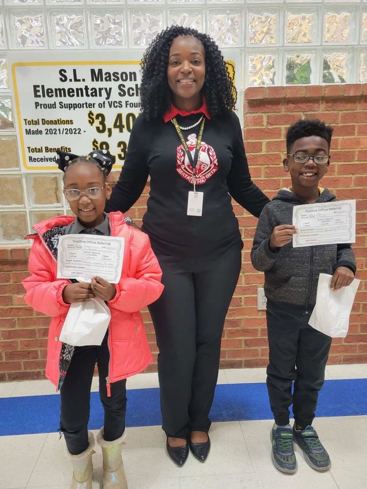 First graders Anaya Cleveland and Caden Lotts receive a positive behavior referral from their teacher Ms. Kiarra Thomas